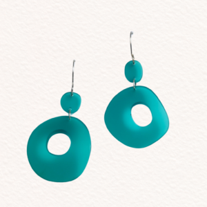 image of sea green acrylic earrings with light shining through them