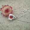 dav Tiny porcelain tea cup with a strawberry and a gold rim hanging on a silver chain necklace