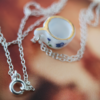 forget me not tea cup necklace 2 Tiny blue and white tea cup necklace hanging on a silver chain
