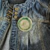 Big green button brooch with green stitching