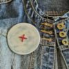 Big button brooch inn blue with red stitching